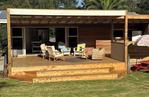 Taupo Bay House | All Decked Out in Beautiful Taupo Bay 2 minute walk to beach and Kids playground