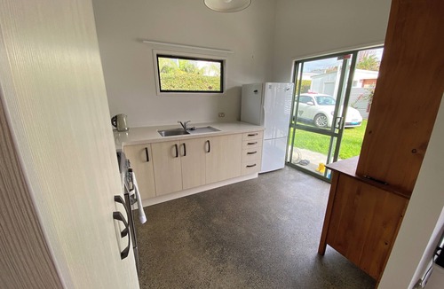 Manly House | Experience a Kiwi beach holiday here, a couple of minutes walk to the sand .