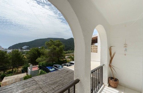 Santa Eulalia del Rio House | Holiday Home "Casita en Cala Llonga" with Sea View, Shared Garden & Pool