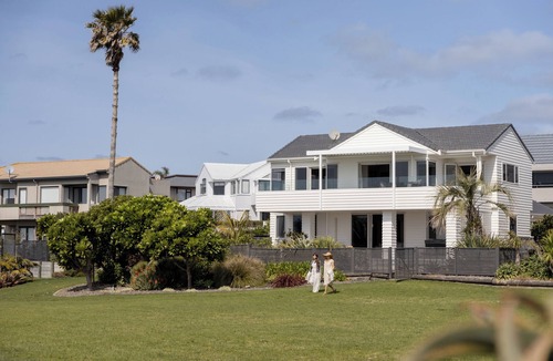 Papamoa Beach House | Oceanfront Abode - 3-Bedroom Beachfront Retreat with 180° Pacific & Mauao Views, Private Spa, Shared Tennis & BBQ