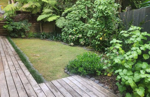 Titirangi Cottage | Romantic Log Cabin Retreat with outdoor bath set amongst the trees