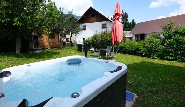Apartment Planica 3 with a garden & a hot tub